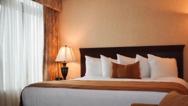 king bed in suite with lots of pillows