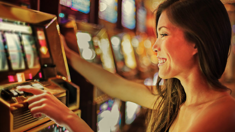 woman playing a slot machine